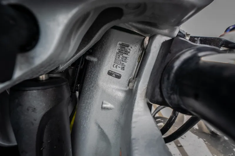 Slide: The Image of Close-up of AMP 333 CC 2025 motorcycle frame with visible label and components. - 62