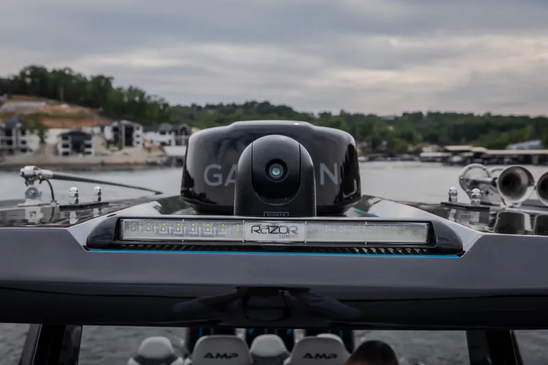 Slide: The Image of Close-up of AMP 333 CC boat's advanced navigation system, 2025 model, on a scenic waterway. - 29