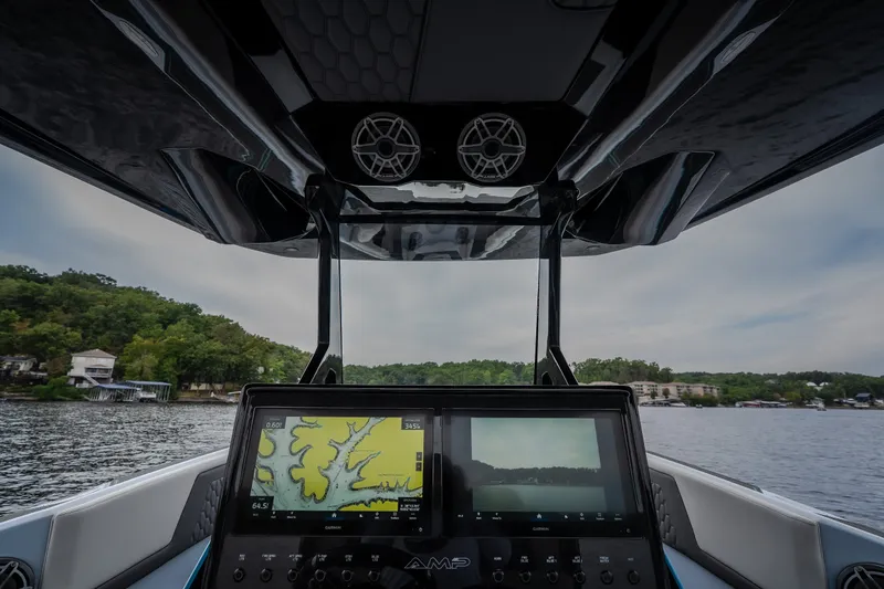 Slide: The Image of Interior view of 2025 AMP 333 CC boat with advanced navigation system on a lake. - 50