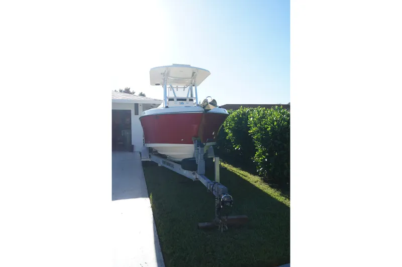 Slide: The Image of 2014 Century 2200 Center Console boat on trailer in driveway. - 16