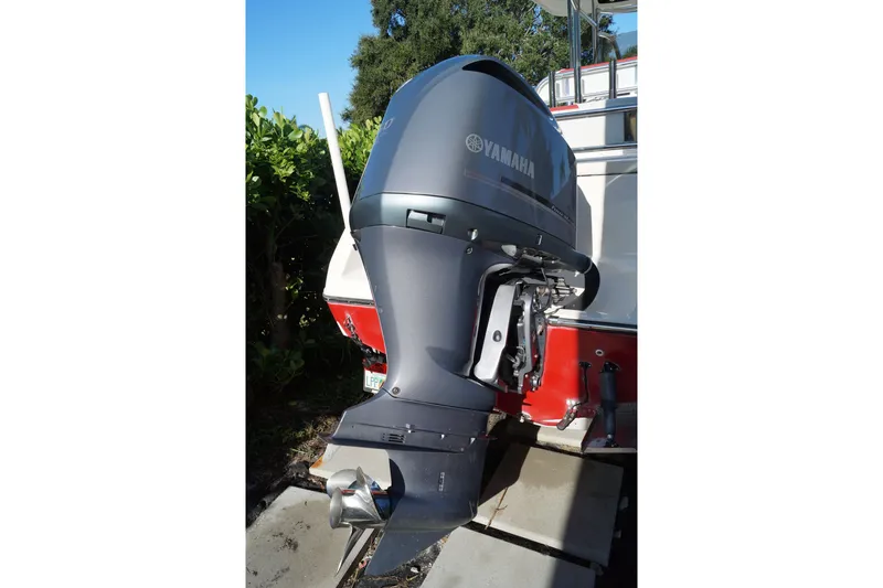 Slide: The Image of Yamaha outboard motor on 2014 Century 2200 Center Console boat, parked outdoors. - 13