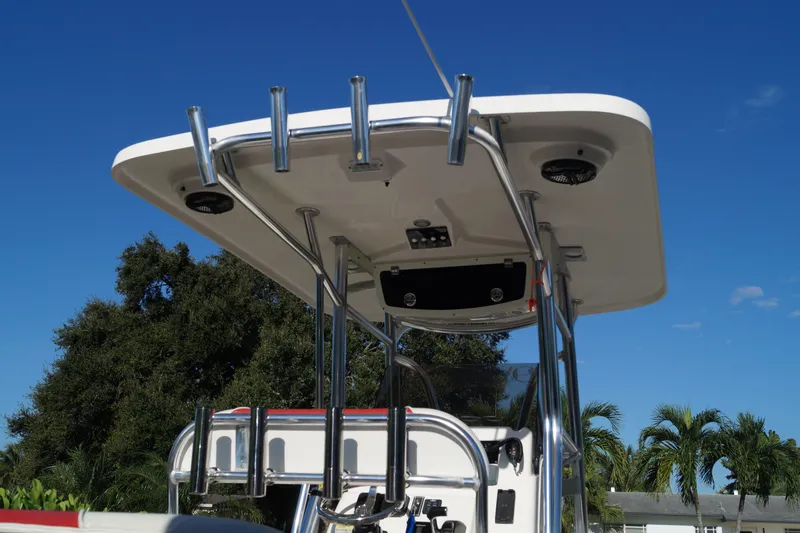 Slide: The Image of 2014 Century 2200 Center Console boat with T-top against blue sky. - 15