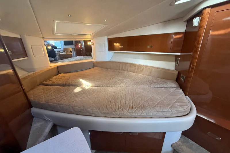 Slide: The Image of Interior cabin of 2010 Sea Ray Sundancer 330 with cozy bed and wooden finishes. - 18