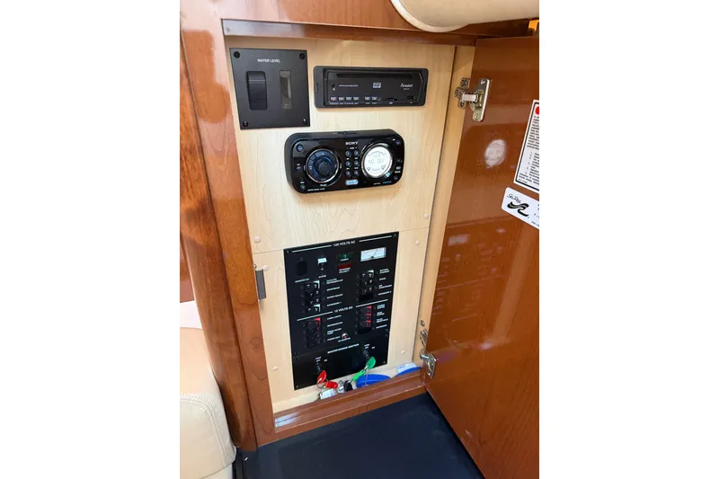 Slide: The Image of Control panel inside 2010 Sea Ray Sundancer 330 boat, featuring audio and electrical systems. - 21