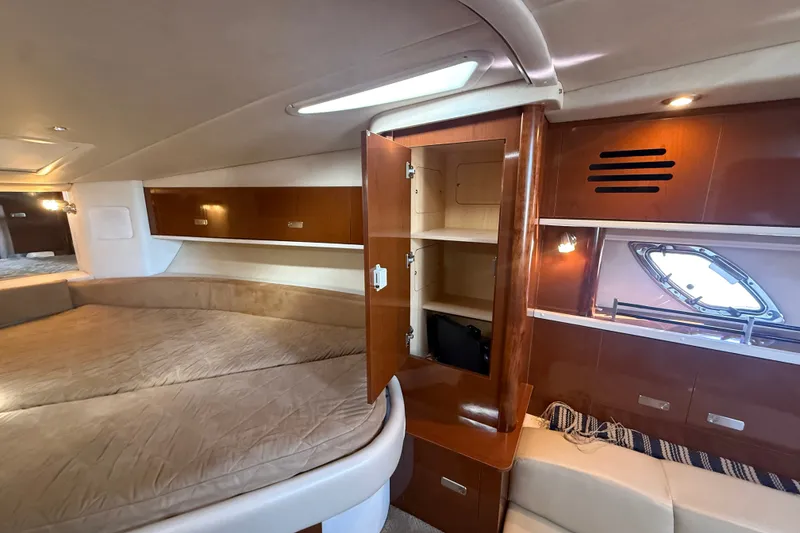 Slide: The Image of Interior of 2010 Sea Ray Sundancer 330 yacht with cozy bed and wooden cabinetry. - 19