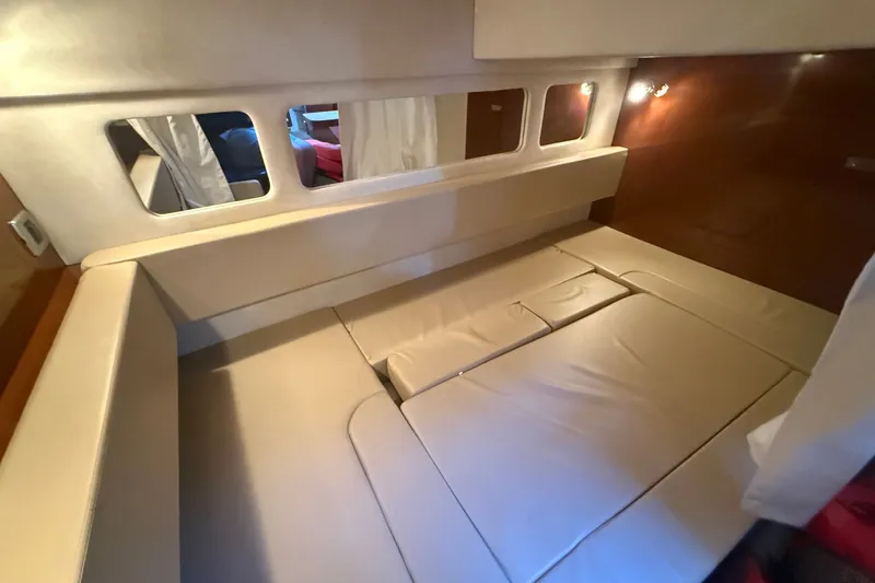 Slide: The Image of Interior cabin of 2010 Sea Ray Sundancer 330 with beige seating and mirrors. - 14