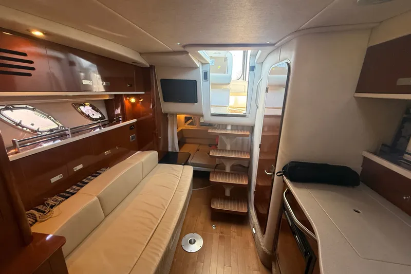 Slide: The Image of Interior of 2010 Sea Ray Sundancer 330 yacht with elegant wood finishes and cozy seating. - 13