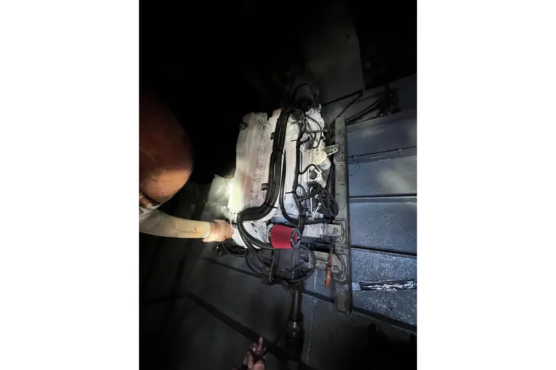 Slide: The Image of 2007 Progressive Industrial engine with red air filter in dimly lit setting. - 24