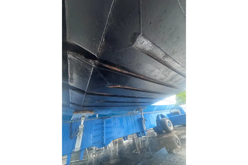 Slide: The Image of Underside view of a 2007 Progressive Industrial vehicle on a blue trailer. - 19