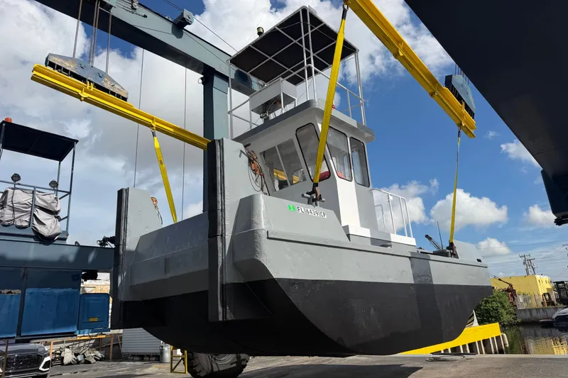 The Image of Boat being lifted by crane at dock, clear sky background, Progressive Industrial 2007 model. - 1