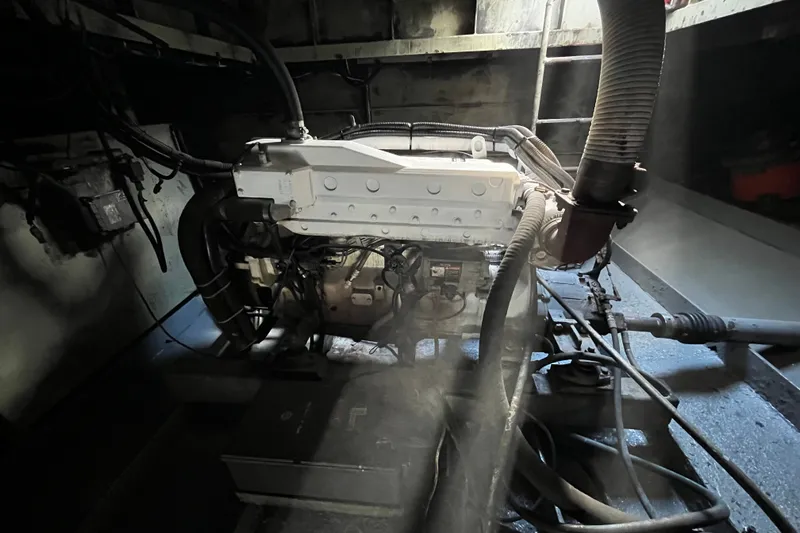 Slide: The Image of Industrial engine room with Progressive Industrial machinery, 2007 model, featuring complex wiring and hoses. - 26