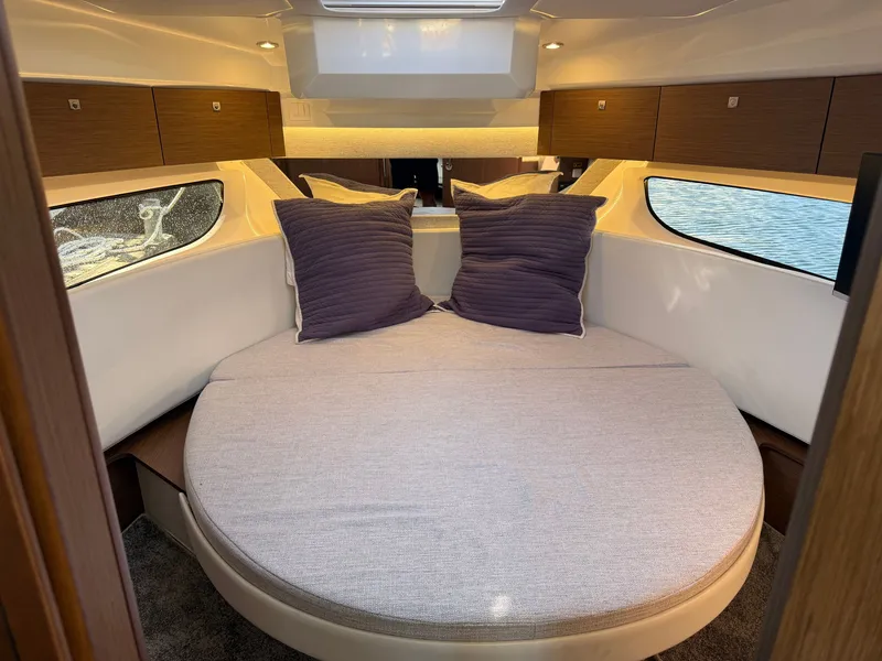 Slide: The Image of The image shows a cozy cabin with a round bed and two pillows. - 23