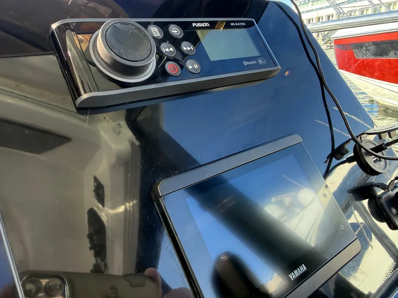 Slide: The Image of The image shows the dashboard of a Jeanneau NC 1095 Coupe with Fusion and Yamaha controls. - 33