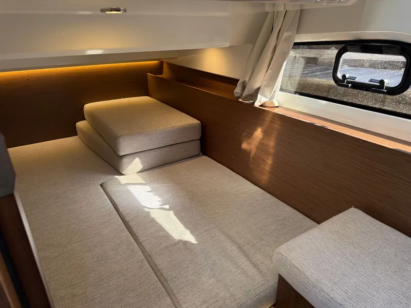 Slide: The Image of Interior of a modern cabin with gray cushions and wood paneling. - 21