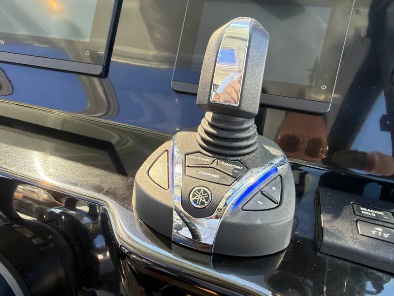 Slide: The Image of Close-up of a modern boat throttle lever with sleek surfaces and electronic controls. - 31