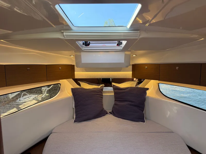 Slide: The Image of The image shows a cozy cabin with a large bed, windows, and a skylight. - 25
