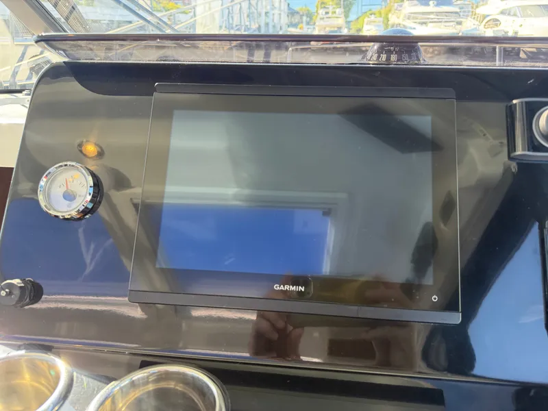 Slide: The Image of The image shows a modern Garmin navigation system on a Jeanneau NC 1095 Coupe boat. - 32