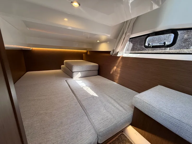 Slide: The Image of Interior of a modern cabin with gray upholstery and wood paneling. - 27