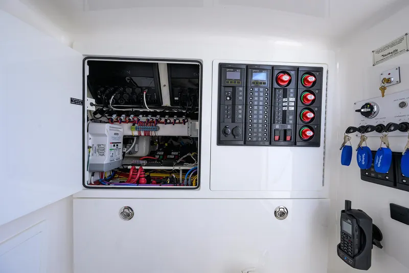 Slide: The Image of Electrical control panel of 2022 Valhalla Boatworks V-41 boat with open compartments. - 44