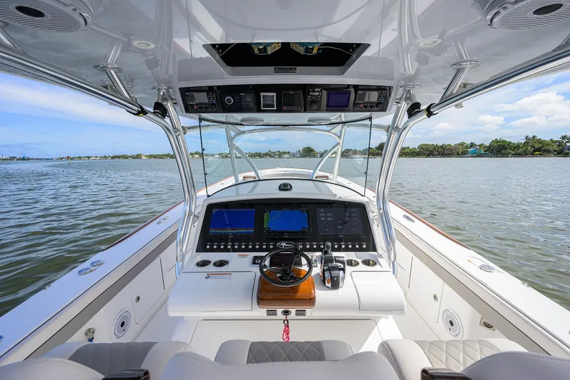 Slide: The Image of 2022 Valhalla Boatworks V-41 helm station with advanced navigation systems on a calm lake. - 30