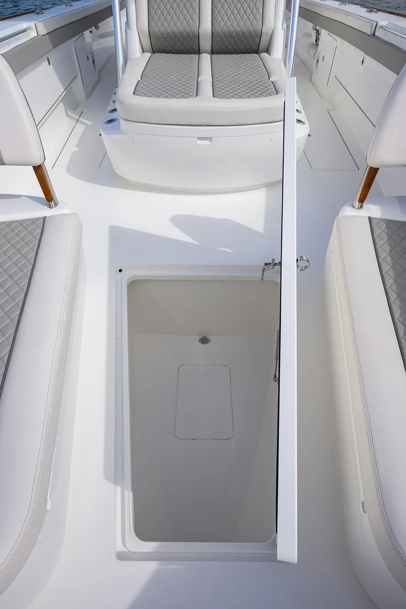Slide: The Image of 2022 Valhalla Boatworks V-41 interior with open storage compartment and cushioned seating. - 17