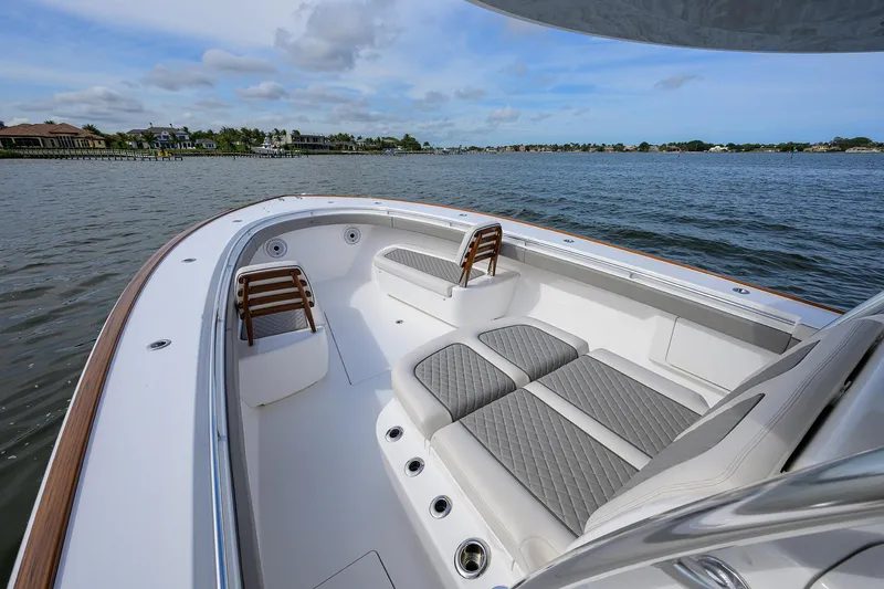 Slide: The Image of 2022 Valhalla Boatworks V-41, spacious deck with cushioned seating, on a serene water backdrop. - 9