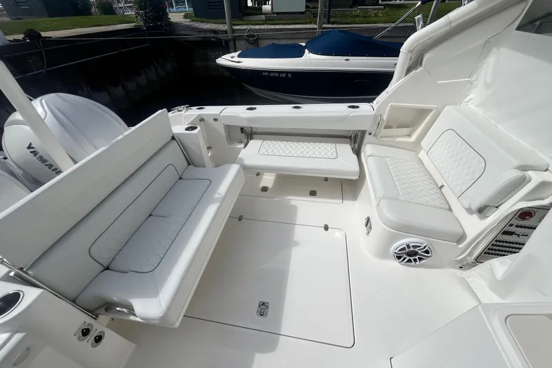 Slide: The Image of 2027 Pursuit DC 326 Dual Console boat interior with white seating and Yamaha engines. - 4