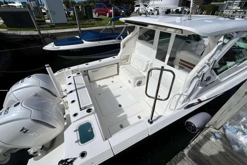 Slide: The Image of 2027 Pursuit DC 326 Dual Console boat with twin Yamaha engines docked at marina. - 0