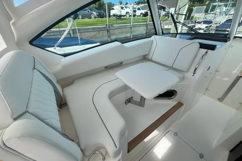 Slide: The Image of Luxurious interior of 2027 Pursuit DC 326 Dual Console boat with white seating. - 18
