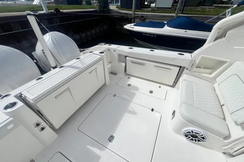 Slide: The Image of 2027 Pursuit DC 326 Dual Console boat interior with seating and storage compartments. - 3