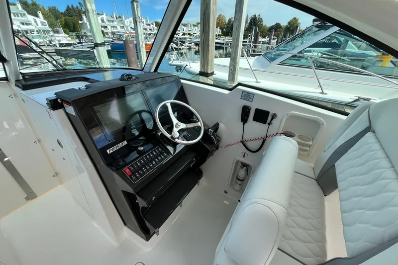 Slide: The Image of Cockpit of 2027 Pursuit DC 326 Dual Console boat with modern steering and controls. - 13