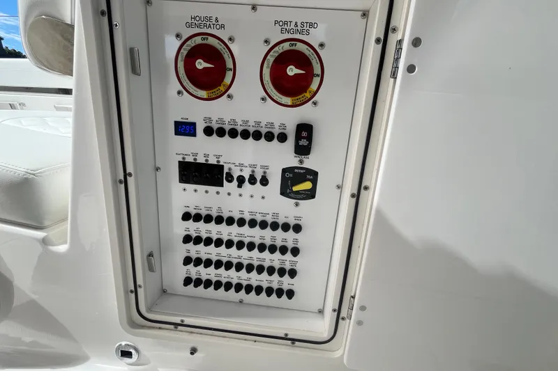 Slide: The Image of Electrical control panel on a 2027 Pursuit DC 326 Dual Console boat. - 11