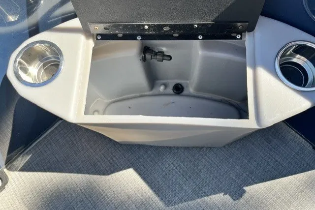 Slide: The Image of 2023 Bentley 180 LE boat storage compartment with cup holders and gray interior. - 3