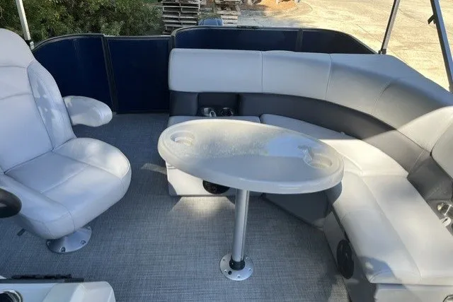 Slide: The Image of 2023 Bentley 180 LE boat interior with plush seating and round table. - 8