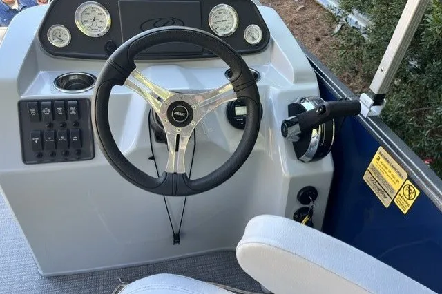 Slide: The Image of Steering console of 2023 Bentley 180 LE boat with gauges and controls. - 2