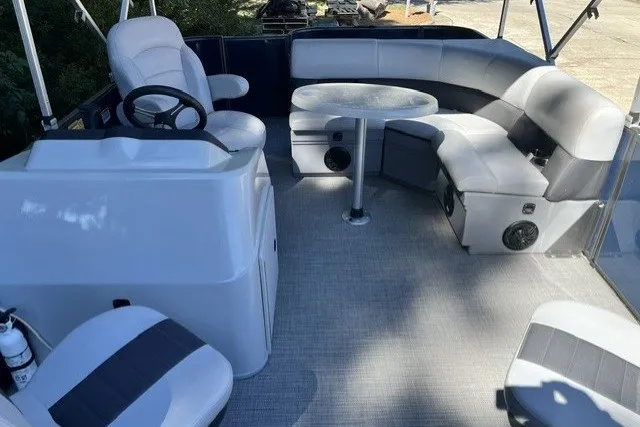 Slide: The Image of 2023 Bentley 180 LE boat interior with seating and steering console. - 9