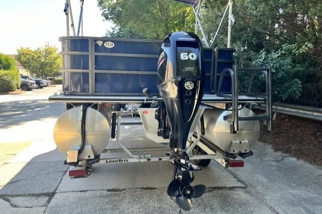 Slide: The Image of 2023 Bentley 180 LE pontoon boat with Mercury 60 HP outboard motor on trailer. - 10