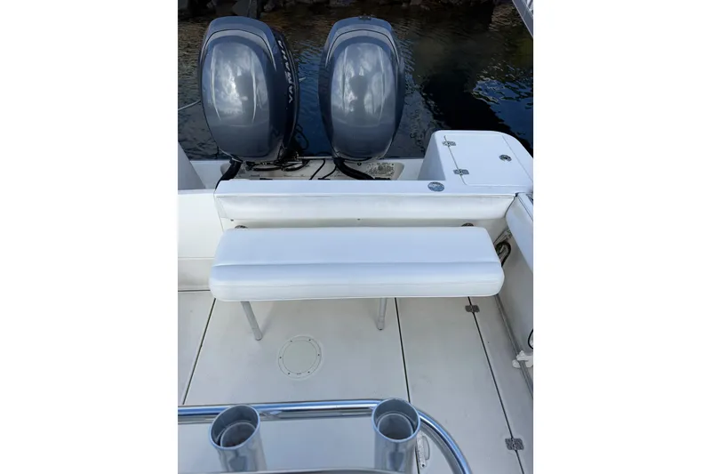 Slide: The Image of 2005 Edgewater 245CC boat with twin outboard motors and white seating. - 11