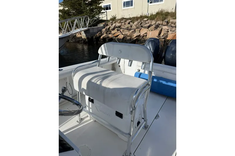 Slide: The Image of 2005 Edgewater 245CC boat interior with cushioned seating and steering wheel. - 9