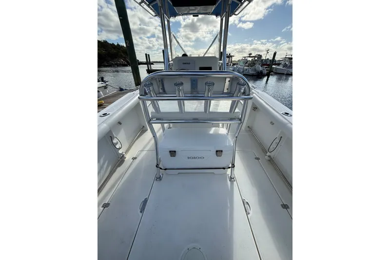 Slide: The Image of 2005 Edgewater 245CC boat interior with seating and storage, docked at marina. - 10