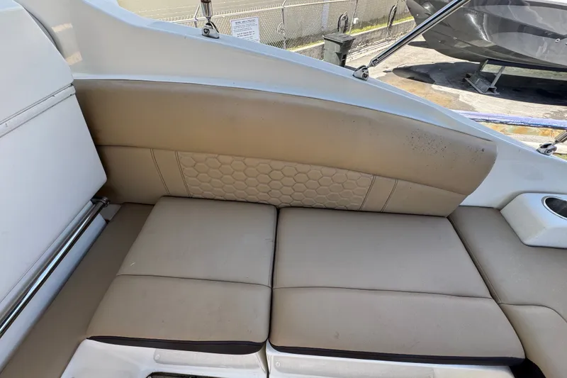 Slide: The Image of 2018 Sea Ray Sundancer 260 interior seating with beige upholstery and hexagonal pattern. - 21