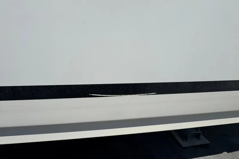 Slide: The Image of 2018 Sea Ray Sundancer 260 with visible hull scratch and black stripe. - 12
