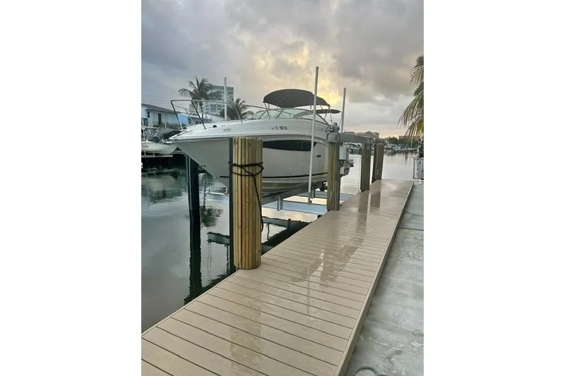The Image of 2018 Sea Ray Sundancer 260 docked at marina during cloudy sunset. - 2