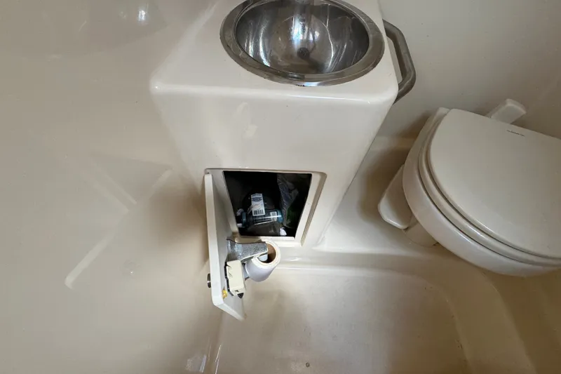 Slide: The Image of 2018 Sea Ray Sundancer 260 bathroom with sink, toilet, and storage compartment. - 48