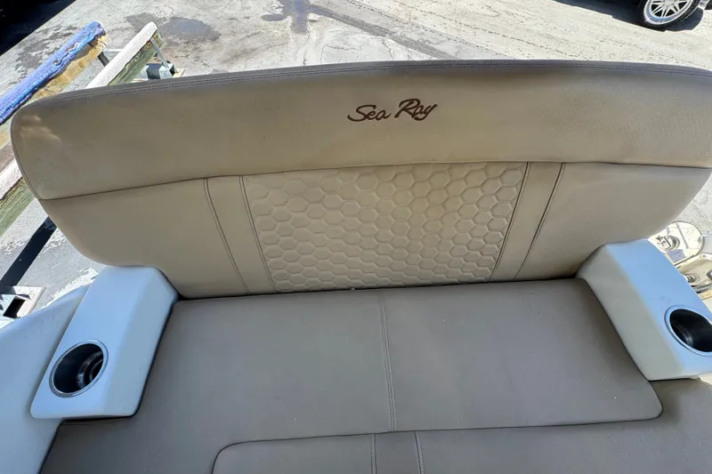 Slide: The Image of 2018 Sea Ray Sundancer 260 boat seat with cup holders and embossed logo. - 25