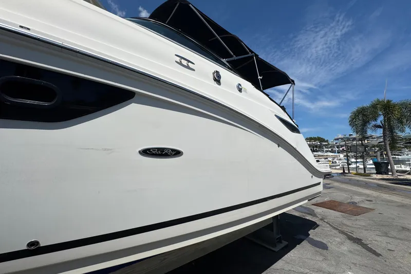Slide: The Image of 2018 Sea Ray Sundancer 260 boat docked under clear blue sky. - 7