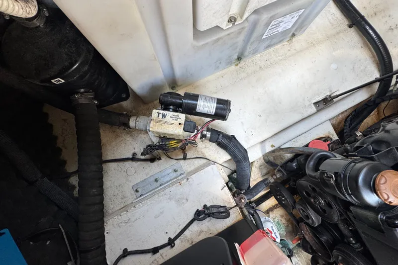 Slide: The Image of Engine compartment of a 2018 Sea Ray Sundancer 260, showing mechanical components and wiring. - 78