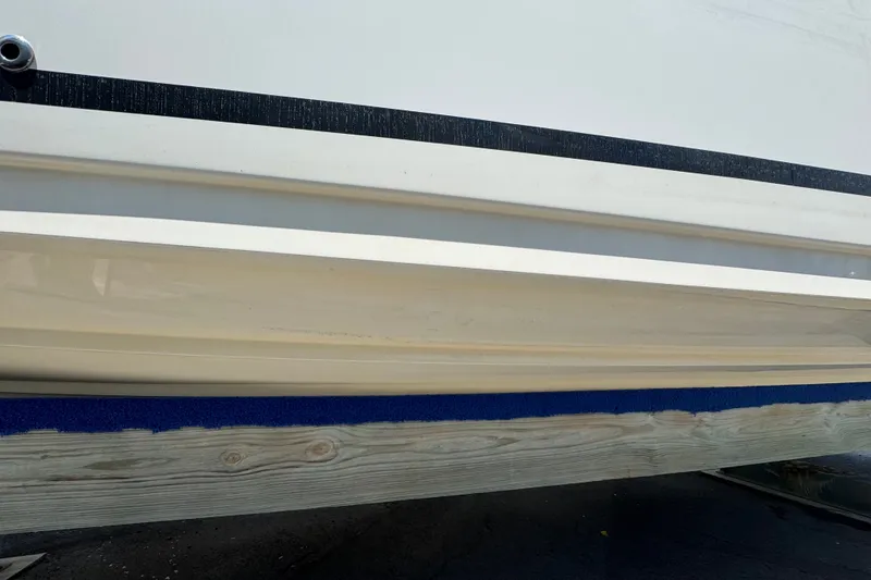 Slide: The Image of Close-up of 2018 Sea Ray Sundancer 260 boat hull on wooden support. - 14
