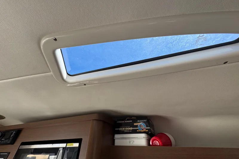 Slide: The Image of Interior view of 2018 Sea Ray Sundancer 260, featuring a skylight and storage area. - 51