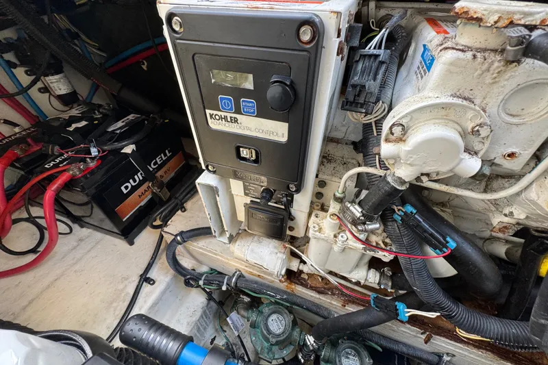 Slide: The Image of Engine compartment of a 2018 Sea Ray Sundancer 260 with Kohler generator and Duracell batteries. - 63
